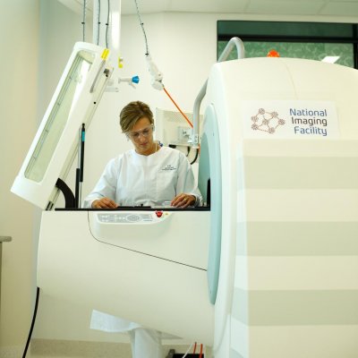 NIF Facility Fellow Dr Karine Mardon with the Positron Emission Tomography/Computed Tomography (PET/CT) hosted at the Centre for Advanced Imaging. 